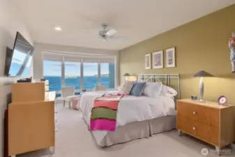 Moving into the Primary Suite, you’ll be greeted by nearly floor-to-ceiling windows that frame breathtaking views of the Olympic Mountains and Puget Sound, with the ever-moving Ferries adding a dynamic touch to the scenery. Imagine waking up each day to this stunning panorama!