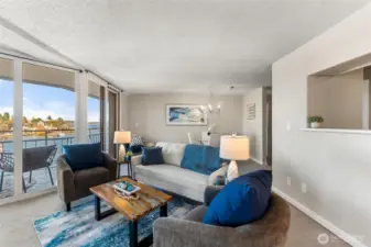 Inviting living area with open sightlines, waterfront views, and seamless access to the private balcony.