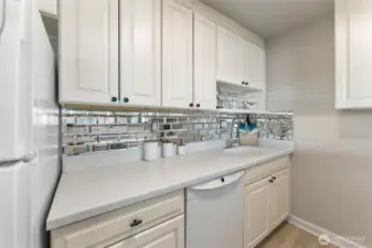 Bright kitchen workspace with tile backsplash, generous counter space, and modern finishes.