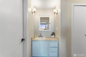 Updated vanity area with modern fixtures and clean, coastal-inspired finishes.