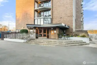 Building exterior and entry showcasing waterfront access and well-maintained grounds.