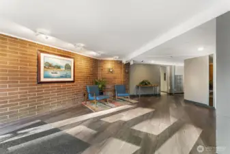 A bright, thoughtfully maintained lobby with comfortable seating and secure access welcomes residents home at Spinnaker Bay.