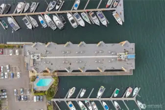 Top-down aerial view highlighting dock access, parking, and pool amenities.