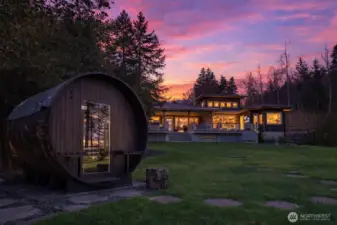 The property includes a 7' x 8' Grandview sauna with an adjacent hot/cold outdoor shower and changing room. The sauna accommodates up to six people and is equipped with a Harvia 8kW KIP heater, reaching 175–185ºF in approximately one hour. The heater can be set for immediate use or programmed up to eight hours in advance.