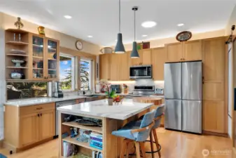 The kitchen is efficiently designed with Quartz countertops, stainless steel farm sink, high end appliances, white oak cabinetry, and a walk-in pantry, prioritizing storage, workflow, and long-term functionality.