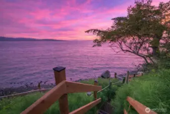 Newly installed treated wood steps provide direct access to over 100 feet of private pebble beach.