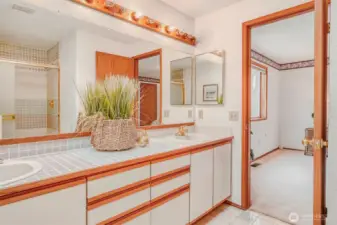 Another view of the primary bath with a dual sink vanity.