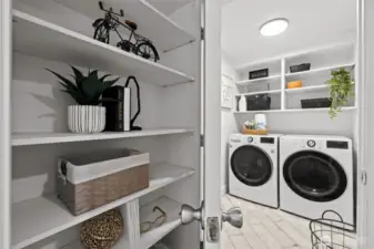 Laundry off lower level hallway with shelving design niche.