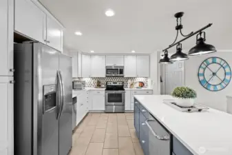 Chic, updated kitchen with soft closing cabinets, island seating and beverage fridg