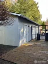 Shop/2 car garage with pavers and ornamental fence.