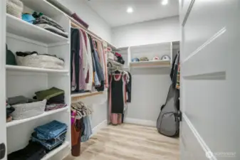 Large walk-in closet with custom shelving in the primary bedroom