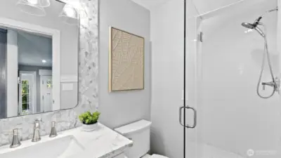 Powder room with a shower right at the front door.