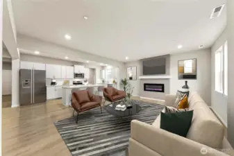 Gourmet kitchen with large center island, quartz counters, loads of cabinets, built-in 48" fridge and in-wall oven & microwave next to your large family room. Actual home is under construction and materials, colors, and finishes will vary. See site agent for details.