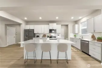 Large center island with eating area. . Actual home is under construction and materials, colors, and finishes will vary. See site agent for details.