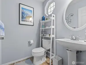 Immediately to the right is the conveniently located powder room.