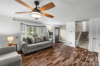 MAIN FLOOR | Enter into the main floor living room. Also on this level you'll find the kitchen, dining room, entrance to the garage, laundry room and bathroom. The stairs lead to the upper level.