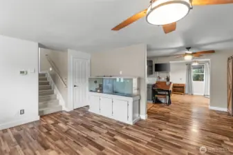 MAIN FLOOR | The stairs lead to the bedrooms on the upper level, and through the door next to the stairs you go down to the lower level rec room.