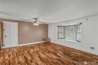 MAIN FLOOR LIVING ROOM | The view as you come up the stairs from the rec room. The door leads to the 2-car garage.