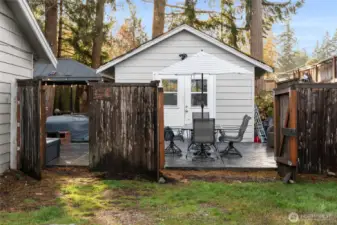 SIDE YARD | Multiple gates open to the backyard for convenience. You will love the big, beautiful stamped concrete patio with so much room for outdoor living . The shop is currently full of furniture, but take a peek inside and imagine the possibilities.