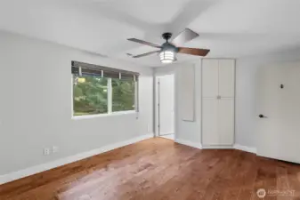 PRIMARY BEDROOM | This room is located at the end of the hallway on the upper level and overlooks the backyard. The door leads to an attached bathroom.