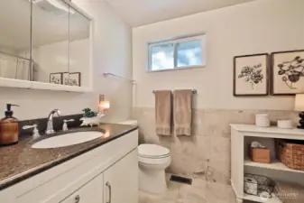 The full bath features lots of tile and