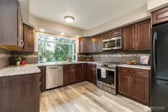 Enjoy quartz counters, tiled backsplash, and a large garden window