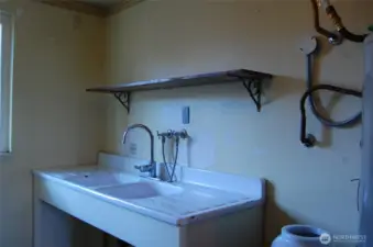 Sinks and counter installed instead of washer & dryer to provide a kitchenette.