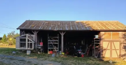 Barn/storage and extra parking with a finished area on the right end behind the doors.