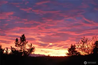 Spectacular sunset fills the sky above your soon to be home in picturesque Port Townsend.