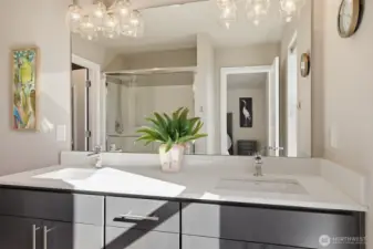 Dual vanities, a glass walk-in shower, stylish fixtures - wow!
