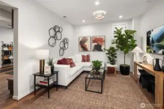 Main floor flex area with white brick tile walls offers versatile living options