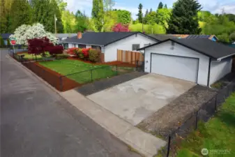 Detached shop/garage with driveway, power and automatic opener.