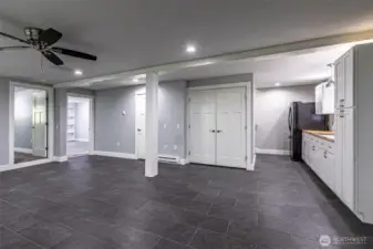 The lower level, fridge with counter space and sink, washer and dryer are behind the double doors
