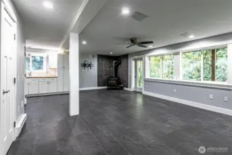 a view of downstairs from the opposite side, that freestanding fireplace can heat the entire home