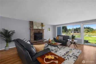 Living room with wood stove insert and views of the backyard & pastures