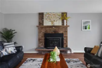 Living room with wood stove insert and views of the backyard & pastures