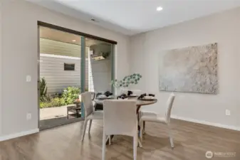 Kitchen eating and dining area overlooks the professionally landscaped sideyard.