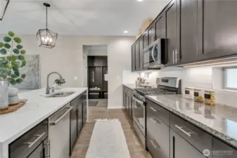 Stainless steel appliances and a large corner pantry round out the kitchen area.