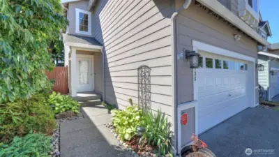 Cement planked siding, metal garage door with garage door openers.  Composition roofing with an aggregate driveway.