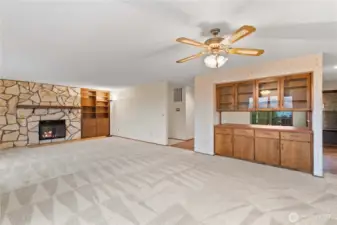 Main floor open living and dining area with cozy fireplace