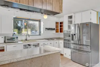 Bright kitchen with window looking out into the front yard where deer walking by may be your morning entertainment