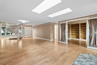 Looking towards the entry way, den and hallway to the 2nd den and primary bath.
