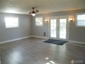 Family room with ceiling fan and french doors.
