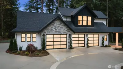 A four-car garage includes an oversized bay fit for a boat or workshop, while ample RV parking and manicured surroundings create a rare blend of function and refinement.