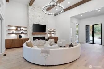 Architectural ceiling beams draw the eye upward, adding depth, character, and timeless craftsmanship to the great room’s dramatic design.