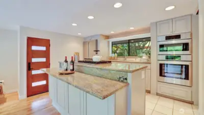 All appliances are included—featuring a double oven and sleek stainless steel refrigerator.