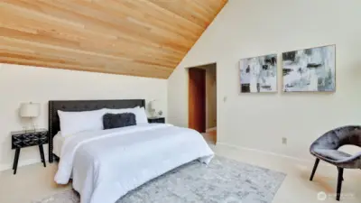 The spacious primary suite on the upper level offers more eye catching wood lined vaulted ceilings, a walk-in closet, two additional closet, and an attached ¾ bath.