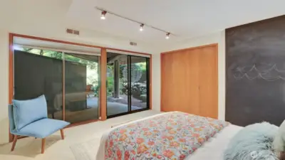 The lower level guest room has slider doors leading you to the front patio space, offering its own little area to sit outside and relax.