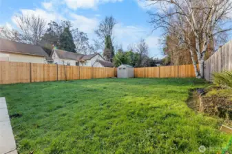 Concrete walkway wraps from front to back yard
