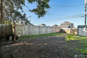 Alley access to driveway with ample parking and a gate